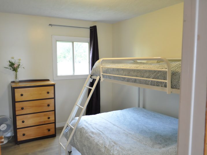 Second bedroom with bunk beds inside The Cove 245B cottage rental near Ottawa.