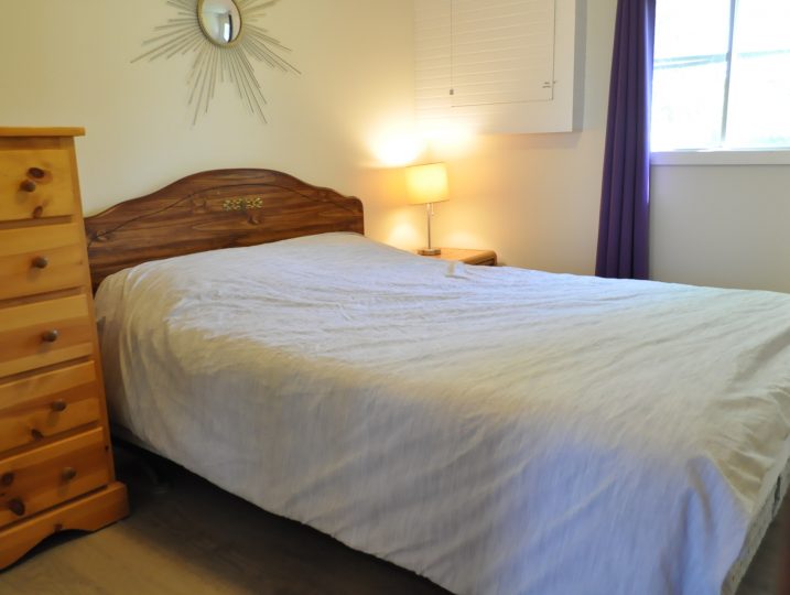 Master bedroom with double bed inside The Cove 245B cottage at White Lake.