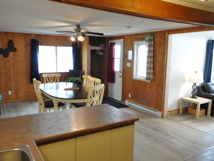 Open-concept kitchen and dining space inside The Cove 245B cottage rental near Ottawa.