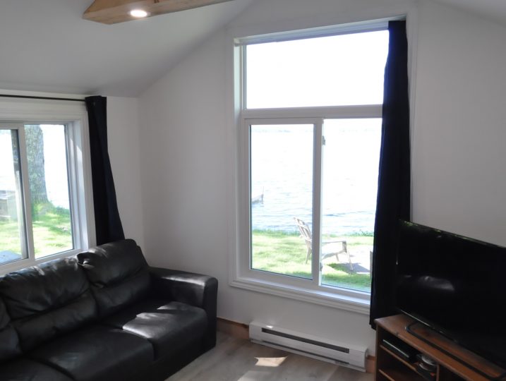 Waterfront view of White Lake through living room windows at The Cove 245B cottage.